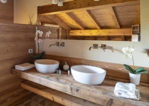 a bathroom with two sinks on a wooden counter at Chalet de l'Atray in Les Gets +21 photos