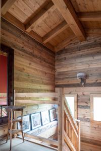 a wooden room with a table and a wooden ceiling at Chalet de l'Atray in Les Gets