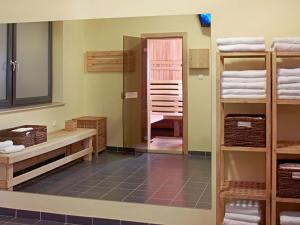 a bathroom with a mirror and a sink and towels at Focus Hotel Gdańsk in Gdańsk