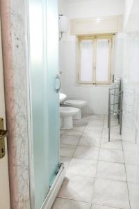 a bathroom with a toilet and a glass shower at N050 - Numana, trilocale in centro con portico e posto auto in Numana