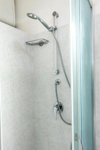 a shower with a shower head in a bathroom at N050 - Numana, trilocale in centro con portico e posto auto in Numana