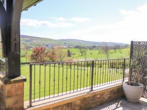 a balcony with a view of a green field at Castleys in Skipton