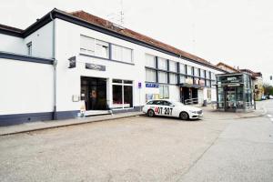 a white car parked in front of a building at Pension am Bahnhof in Nürtingen