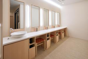 a bathroom with a sink and many mirrors at Hotel Resol Trinity Osaka in Osaka