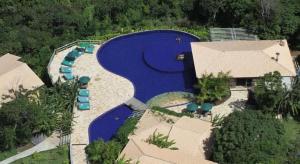an aerial view of a large blue swimming pool at Studio Luxo Ecológico. in Maceió