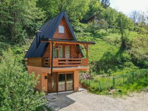 a house with a black roof on a hill at Malena Plivsko Jezero Jajce in Jajce