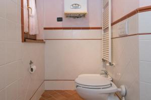 a small bathroom with a toilet and a sink at Oleandro in Santa Luce +17 photos