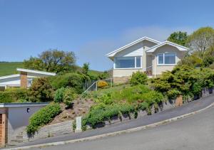a house with a garden on the side of a street at Bay View Bungalow in Combe Martin
