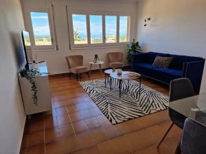 a living room with a blue couch and a table at Sant Gaieta H in Begur