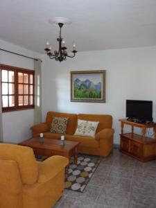 艾爾帕索的住宿－Apartamentos Casa Rosán, junto a la Caldera de Taburiente，客厅配有两张沙发和一台电视机