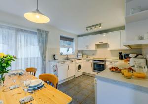 a kitchen with a table and a dining room at Seaview Moorings in Porthleven