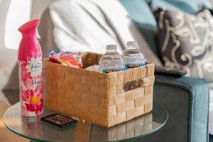 a basket of water bottles on a table next to aumedumedumedumedumed at Opulent 2 Bedroom City Centre Apartment in Nottingham