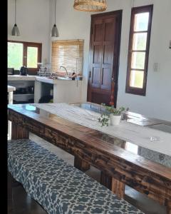 a kitchen with a large wooden table in a room at CASA CAFAYATE LA SOÑADA in Cafayate