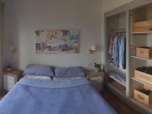 a bedroom with a blue bed and a closet at Ibiza in Begur