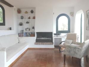 a living room with a couch and a fireplace at Ibiza in Begur