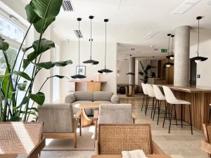 a living room with a table and chairs at ADELANTE Boutique Hotel in Berlin