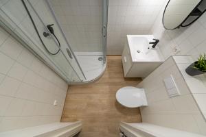 a bathroom with a toilet and a sink and a shower at UAB Laisvės alėjos viešbutis in Kaunas