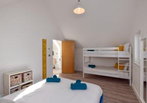 a small bedroom with two bunk beds and a hallway at Beach House in Northam