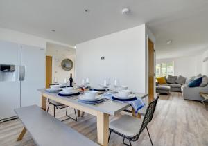 a dining room and living room with a table and chairs at Beach House in Northam
