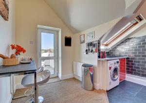 a laundry room with a washer and dryer at The Bolthole in Croyde