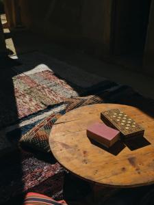 a wooden table with two books on top of it at Nashdeen Eko Lodge in ‘Izbat Zaydān