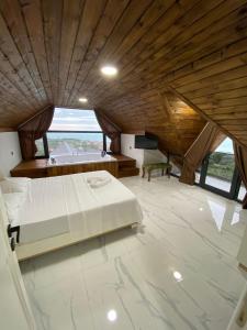 a large bedroom with a bed and a wooden ceiling at VİLLA DENİZ , KiRAZ in Trabzon