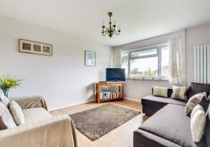 a living room with a couch and a tv at Burrows Retreat in Braunton