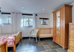 a bedroom with a bed and a table and chairs at Bramble Cottage in Barbrook