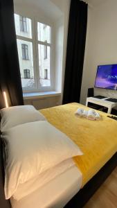 a bedroom with a bed with a laptop on a desk at Central Rooms Apartment in Toruń