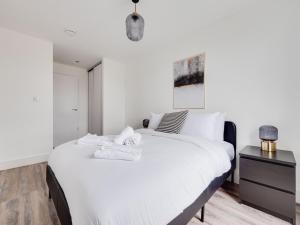 a bedroom with a large white bed and a nightstand at Modern 2 Bedroom Apartment Manchester Media City in Manchester