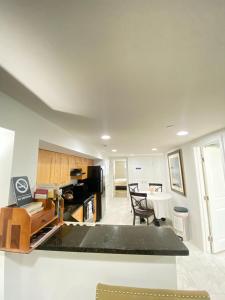 a kitchen and living room with a table and chairs at Lovely Remodeled 2bdrm Basement Home in Washington, D.C.