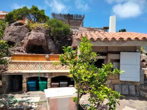 an outside view of a house with a rock at limone in Carloforte