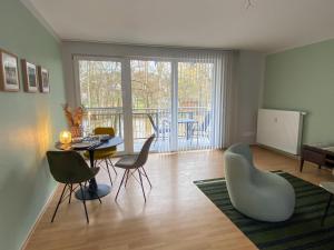 a living room with a table and chairs and a dining room at Apartment Lahnblick in Marburg an der Lahn