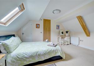 a bedroom with a bed and a desk in it at Chapel Loft in Lynmouth