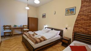 a bedroom with a bed and a brick wall at Guesthouse Kartli in Tbilisi City