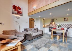 a living room with a couch and a table at Cider Pound in Bampton