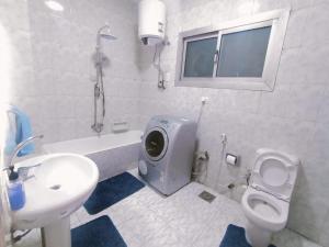 a bathroom with a sink and a toilet and a tub at Nile view apartment in Cairo