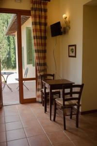 a dining room with a table and chairs and a patio at Appartamenti Casalsole in Cerreto Guidi