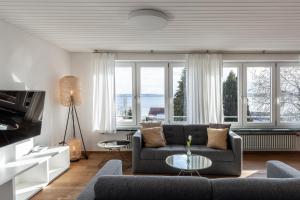 ein Wohnzimmer mit einem Sofa und einem Tisch in der Unterkunft Villa Neugarten in Hagnau