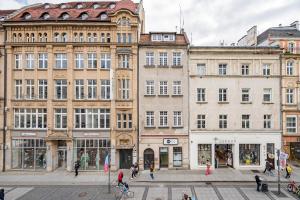 a group of buildings in a street with people walking at NiceOne Apartment Number 1 - W samym Centrum! in Wrocław