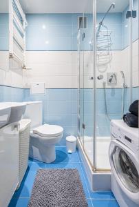 a blue and white bathroom with a toilet and a shower at NiceOne Apartment Number 1 - W samym Centrum! in Wrocław