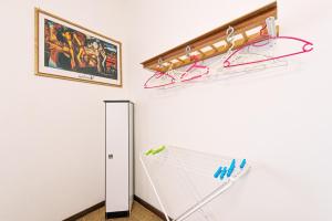 a white room with an umbrella and a wall at La Romana Antica in Madonna di Fornelli