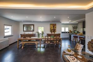 a kitchen and dining room with a table and chairs at Advania Country House in Lourinhã