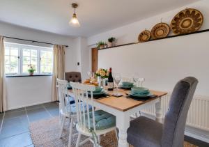 a dining room with a table and chairs at Court Cottage in Berrynarbor