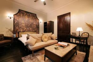 a living room with a couch and a bed at High-class French villa 168m2 by SSens Homes in Hanoi