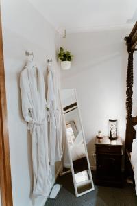 una habitación con toallas blancas colgadas en la pared en The Garden Suite, en The Patch