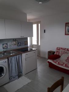 a kitchen with a sink and a stove in a room at Appartamento Cavo in Cavo