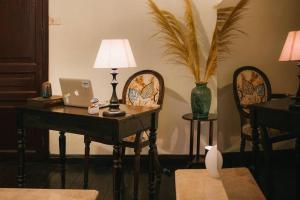 a room with a desk with a lamp and a laptop at High-class French villa 168m2 by SSens Homes in Hanoi
