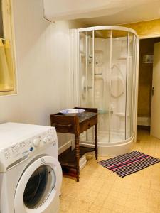 a washing machine in a bathroom with a shower at Les Forrières Maison de Campagne in Thil-Manneville +11 photos