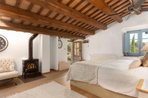 a bedroom with a bed and a wood stove at Can Font de Muntanya Turisme Rural in Cruïlles